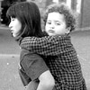 Lil sister on small asian girl's back